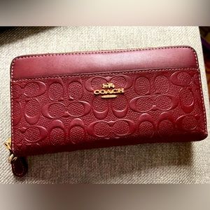 Burgundy coach wallet used